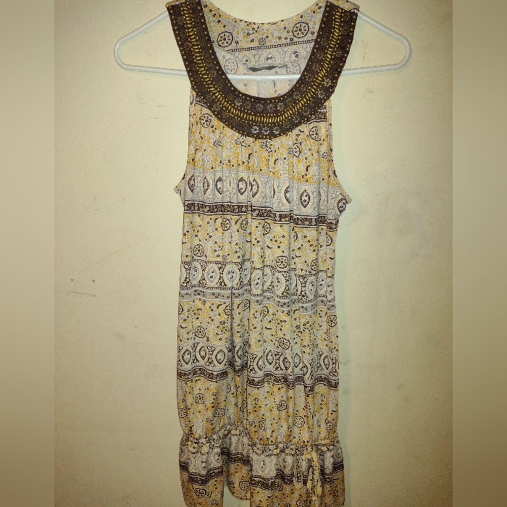 A yellow mini dress with brownish pearls.  In a size UK 12. Max, a UAE brand